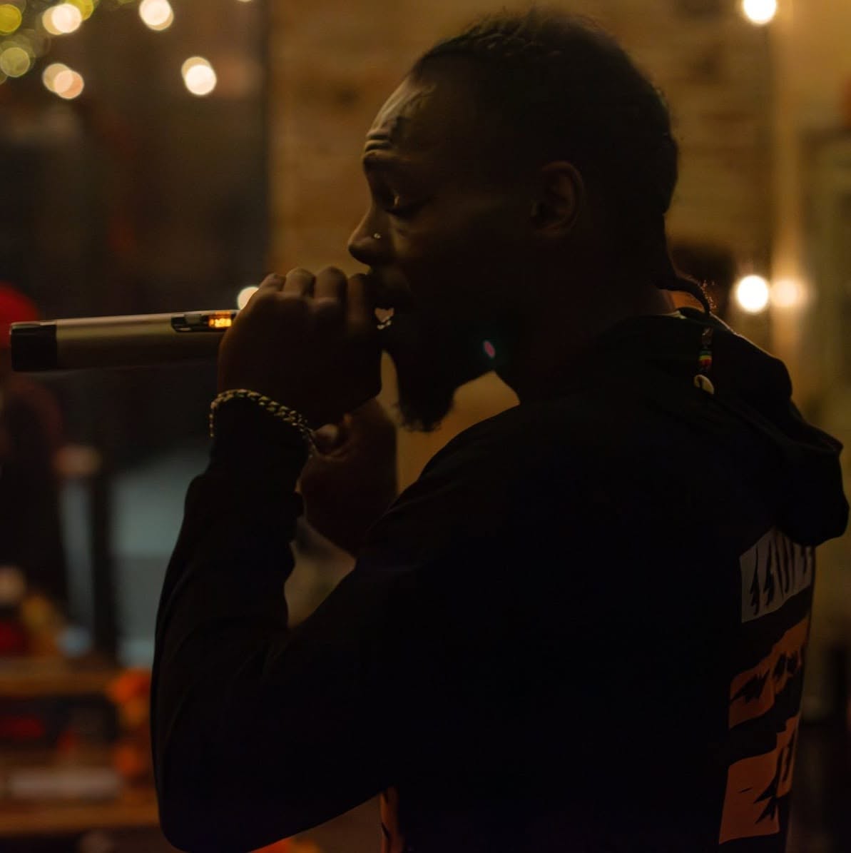 Aboog Carter performing in warm stage light