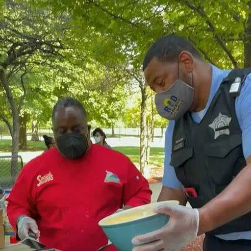 Michael Airhart serving food with a community partner